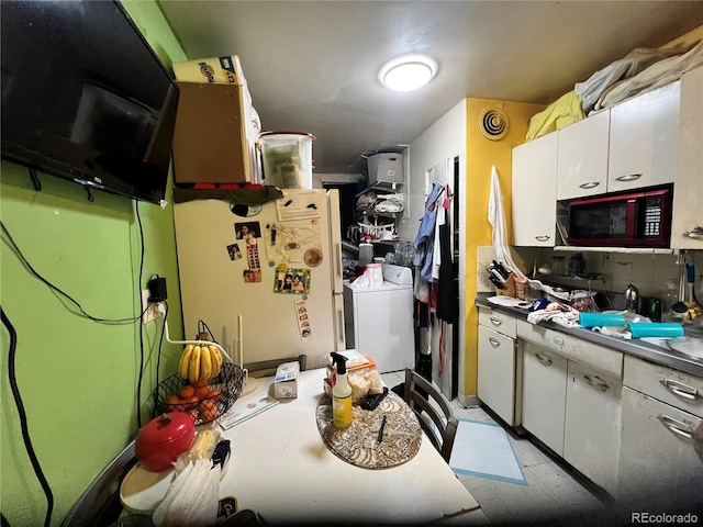 kitchen with washer / clothes dryer, white cabinets, and white fridge