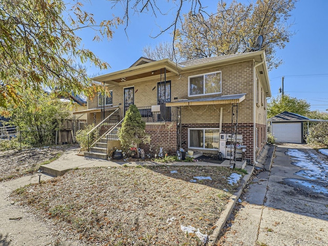 view of front of house with a porch, a garage, and an outdoor structure