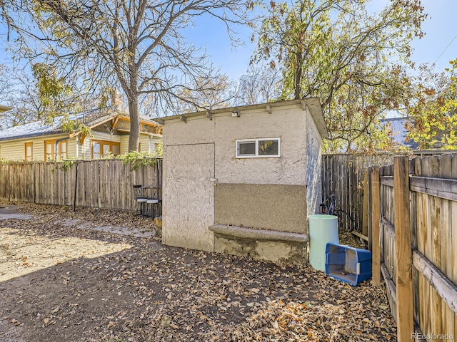 view of side of property featuring a storage unit