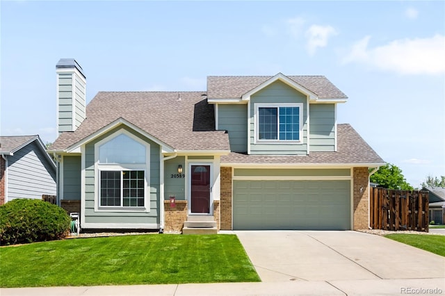 20389 E Powers Pl, Centennial, CO 80015 - view of front of property featuring driveway, roof with shingles, brick siding, and an attached garage