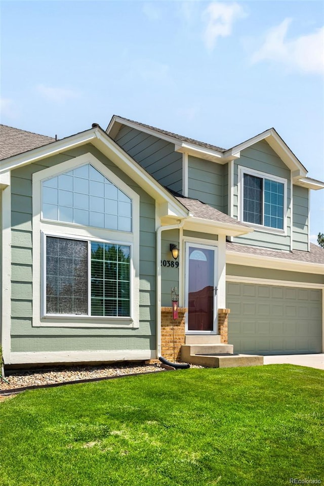 20389 E Powers Pl, Centennial, CO 80015 - view of front facade with an attached garage, a front lawn, concrete driveway, and roof with shingles