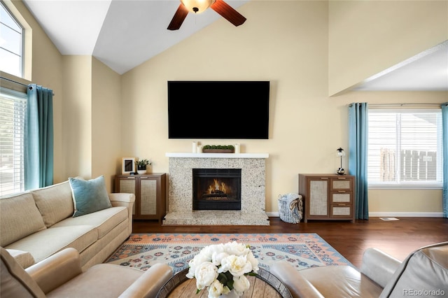 20389 E Powers Pl, Centennial, CO 80015 - living room with a ceiling fan, dark wood-type flooring, a fireplace, lofted ceiling, and plenty of natural light