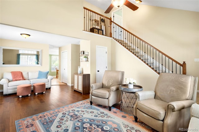 20389 E Powers Pl, Centennial, CO 80015 - living area featuring dark wood-style floors, a ceiling fan, stairs, and a towering ceiling