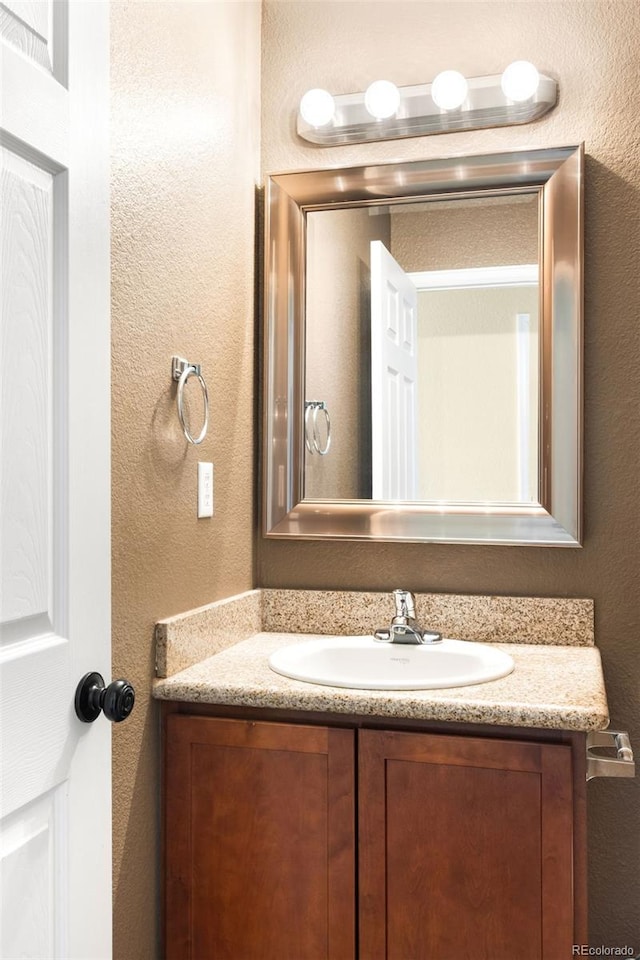 20389 E Powers Pl, Centennial, CO 80015 - bathroom featuring vanity and a textured wall