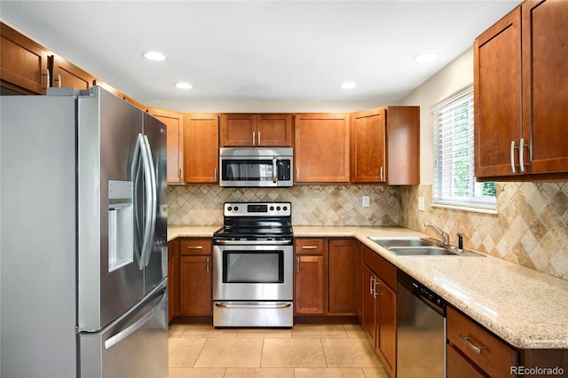 20389 E Powers Pl, Centennial, CO 80015 - kitchen with stainless steel appliances, light tile patterned floors, brown cabinetry, tasteful backsplash, and recessed lighting