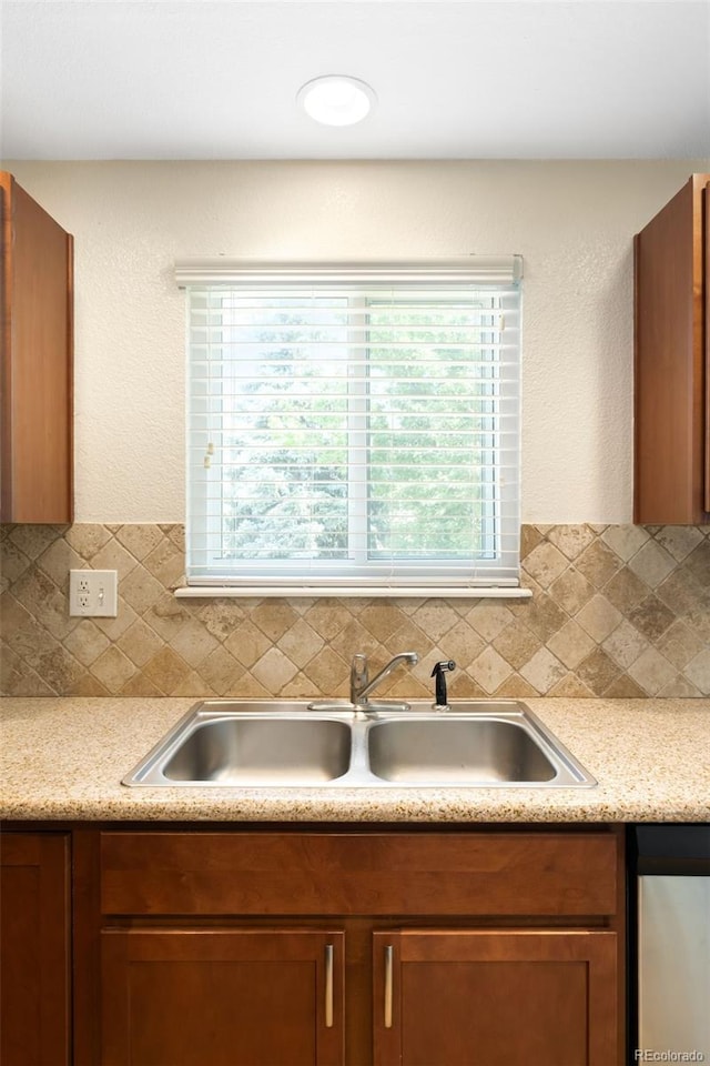 20389 E Powers Pl, Centennial, CO 80015 - kitchen featuring decorative backsplash, light countertops, and brown cabinets