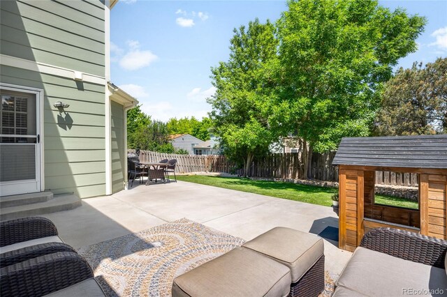 20389 E Powers Pl, Centennial, CO 80015 - fenced backyard with a patio, entry steps, and outdoor dining area