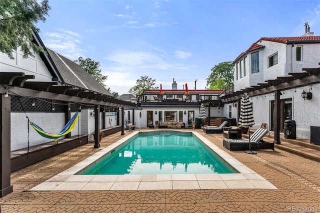 view of pool with an outdoor hangout area, a pergola, and a patio