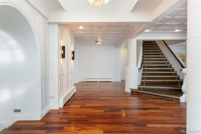 interior space with dark wood-type flooring and baseboard heating