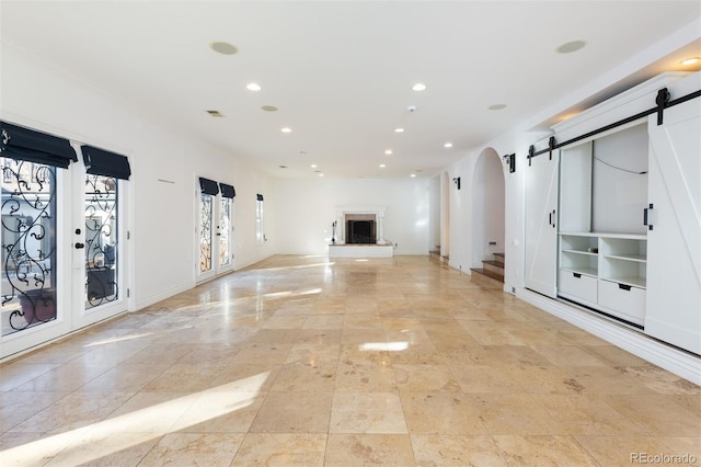 unfurnished living room featuring a barn door