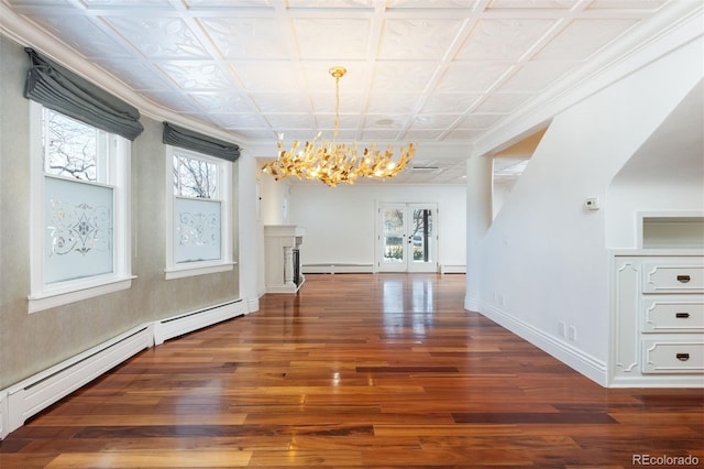 unfurnished dining area featuring a wealth of natural light, baseboard heating, and french doors