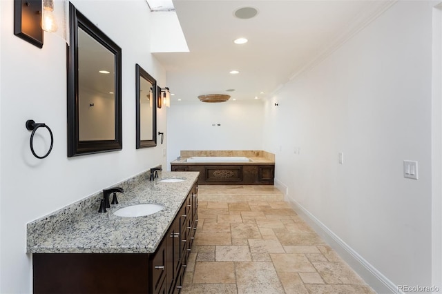 bathroom with vanity, crown molding, and a bathing tub