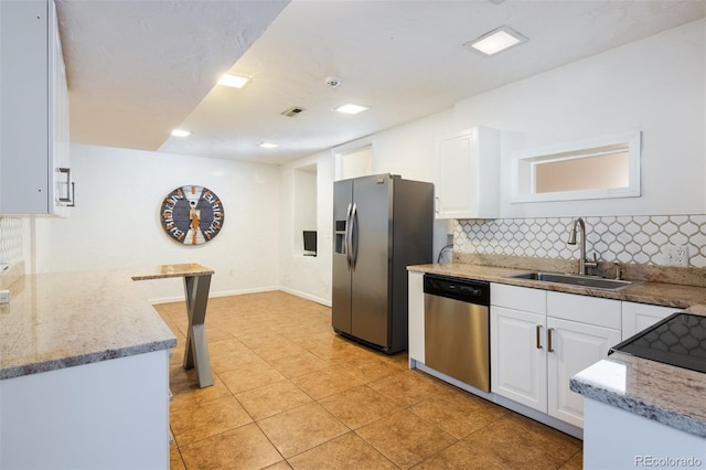 kitchen featuring white cabinetry, stainless steel appliances, sink, and light stone counters