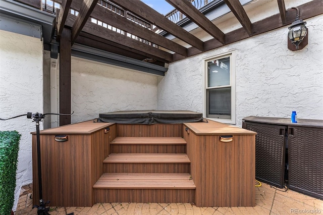 wooden terrace with a hot tub