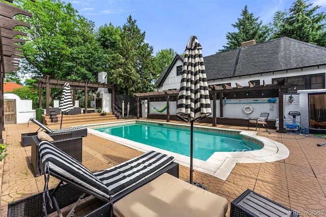 view of swimming pool featuring a patio area and a pergola