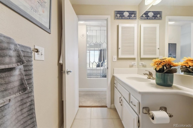 bathroom featuring tile patterned floors, baseboards, and vanity