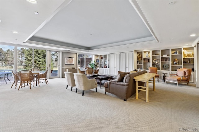living room featuring recessed lighting, light carpet, and a raised ceiling