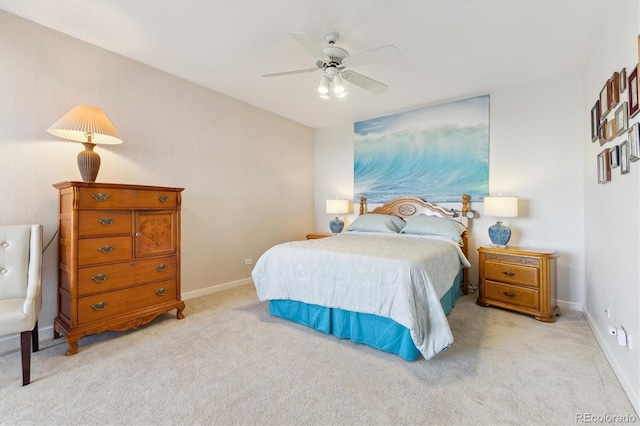 bedroom featuring baseboards, light carpet, and a ceiling fan