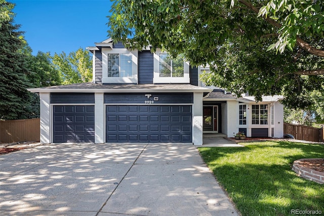 9924 Silver Maple Way, Highlands Ranch, CO 80129 - view of front of house featuring concrete driveway, a garage, brick siding, and a shingled roof