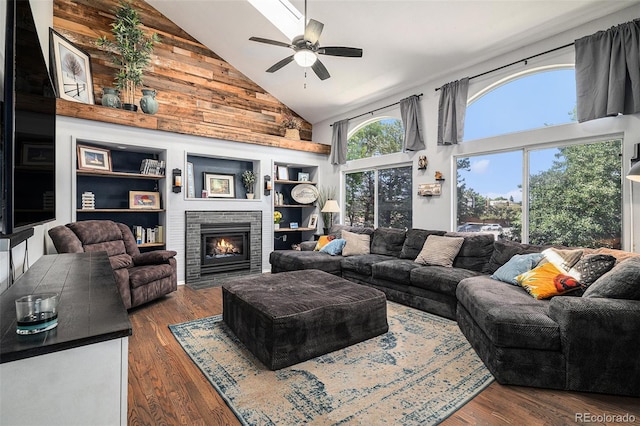 9924 Silver Maple Way, Highlands Ranch, CO 80129 - living area featuring high vaulted ceiling, dark wood-type flooring, a ceiling fan, a fireplace, and built in shelves