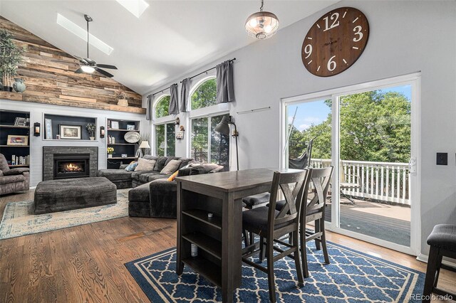 9924 Silver Maple Way, Highlands Ranch, CO 80129 - dining space featuring a skylight, wood finished floors, a ceiling fan, a brick fireplace, and high vaulted ceiling