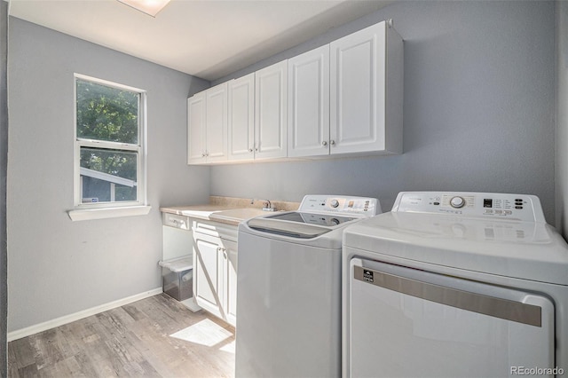 9924 Silver Maple Way, Highlands Ranch, CO 80129 - laundry room featuring light wood-type flooring, washer and clothes dryer, and cabinet space