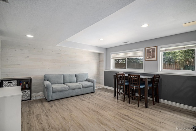 9924 Silver Maple Way, Highlands Ranch, CO 80129 - living room featuring wood finished floors, wood walls, recessed lighting, and a textured ceiling