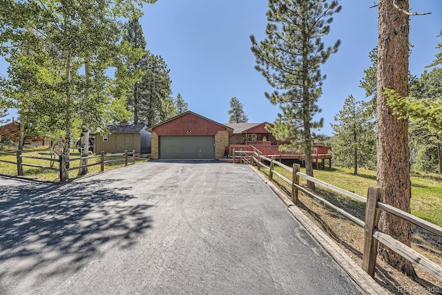 ranch-style house featuring an outdoor structure and a garage