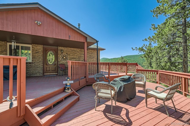 wooden terrace with a mountain view and an outdoor hangout area