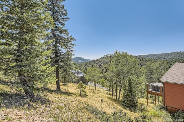 view of mountain feature with a view of trees