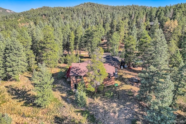 birds eye view of property featuring a mountain view and a forest view