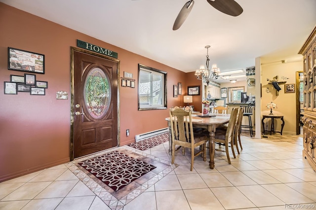 dining room with ceiling fan with notable chandelier, baseboard heating, and light tile patterned flooring