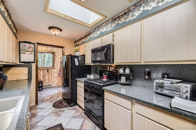 kitchen with tasteful backsplash, a skylight, black appliances, baseboard heating, and sink