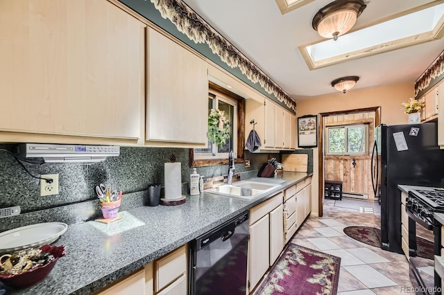 kitchen with a skylight, dishwasher, stainless steel gas stove, sink, and decorative backsplash