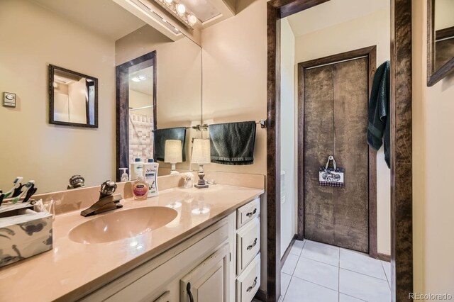 bathroom featuring tile patterned flooring and vanity