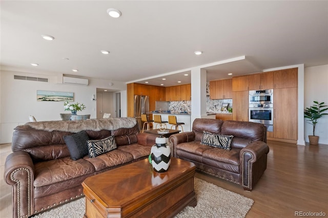 1020 15th St Unit 42A, Denver, CO 80202 - living area with a wall mounted air conditioner, wood finished floors, and recessed lighting