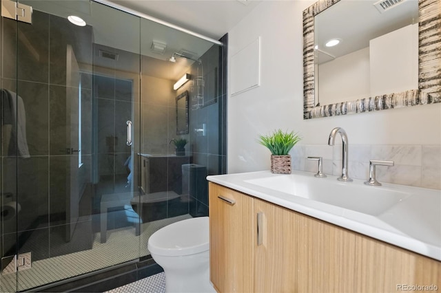 1020 15th St Unit 42A, Denver, CO 80202 - bathroom featuring toilet, vanity, tile patterned floors, and a stall shower