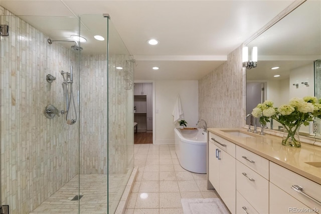 1020 15th St Unit 42A, Denver, CO 80202 - bathroom featuring a shower stall, a freestanding bath, double vanity, and recessed lighting