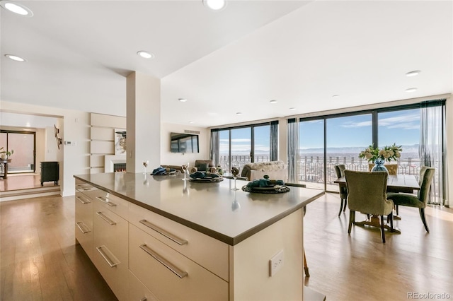 1020 15th St Unit 42A, Denver, CO 80202 - kitchen with light wood-type flooring, modern cabinets, a center island, a wall of windows, and recessed lighting