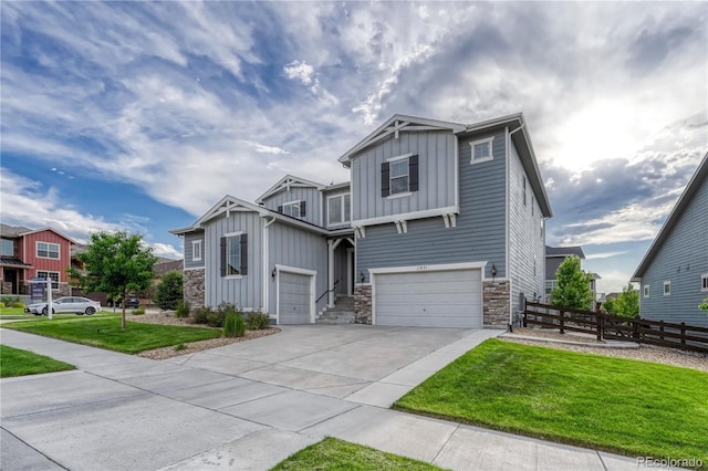 11821 Discovery Ln, Parker, CO 80138 - view of front of property with board and batten siding, stone siding, an attached garage, and driveway