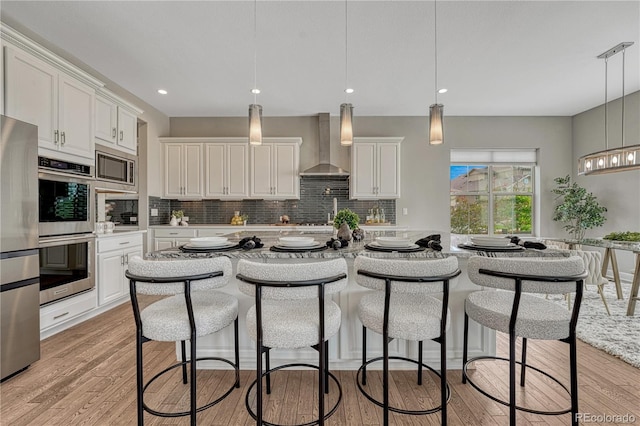 11821 Discovery Ln, Parker, CO 80138 - kitchen featuring wall chimney exhaust hood, stainless steel appliances, decorative backsplash, light countertops, and recessed lighting