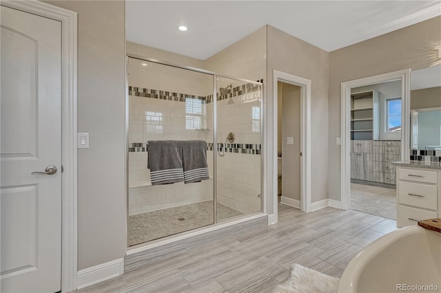 11821 Discovery Ln, Parker, CO 80138 - full bath featuring a shower stall, a bathtub, recessed lighting, and vanity