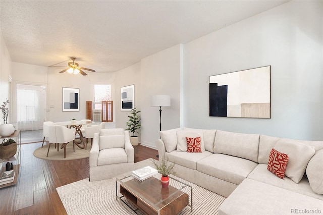 living room featuring hardwood / wood-style flooring and ceiling fan