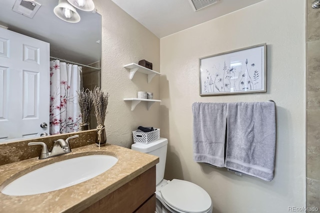 bathroom featuring vanity, toilet, and a shower with shower curtain