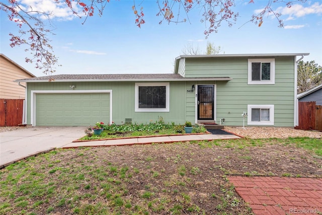 15628 E Girard Pl, Aurora, CO 80013 - tri-level home featuring fence, concrete driveway, and a garage