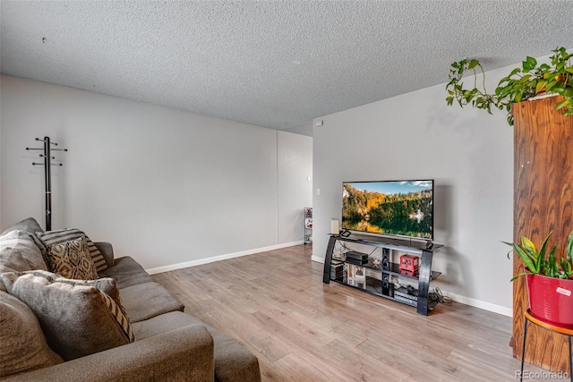 15628 E Girard Pl, Aurora, CO 80013 - living room with wood finished floors, a textured ceiling, and baseboards