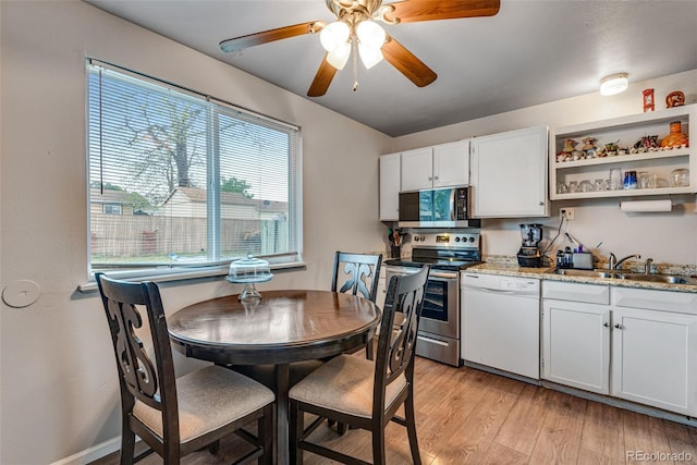 15628 E Girard Pl, Aurora, CO 80013 - kitchen featuring appliances with stainless steel finishes, a sink, a ceiling fan, white cabinets, and light wood-style flooring