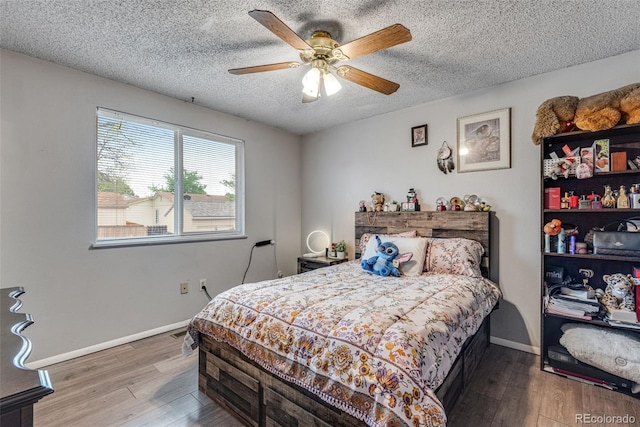 15628 E Girard Pl, Aurora, CO 80013 - bedroom with wood finished floors, a textured ceiling, baseboards, and a ceiling fan