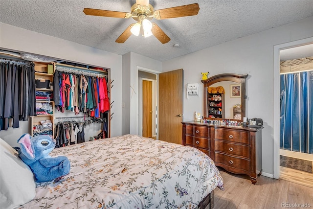 15628 E Girard Pl, Aurora, CO 80013 - bedroom with a textured ceiling, wood finished floors, a ceiling fan, a closet, and baseboards