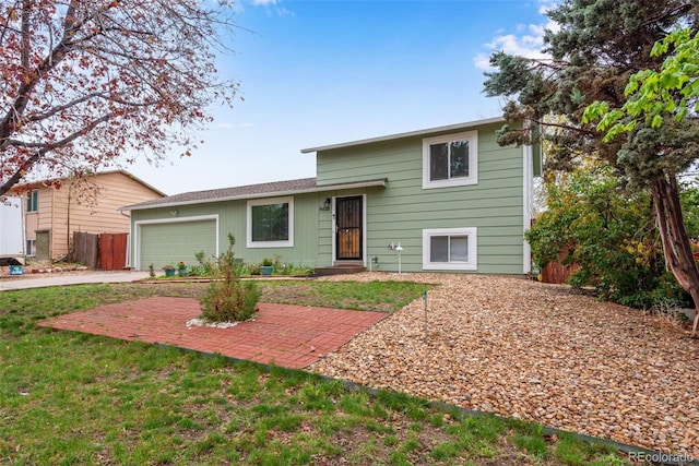 15628 E Girard Pl, Aurora, CO 80013 - split level home with an attached garage, concrete driveway, and a front yard